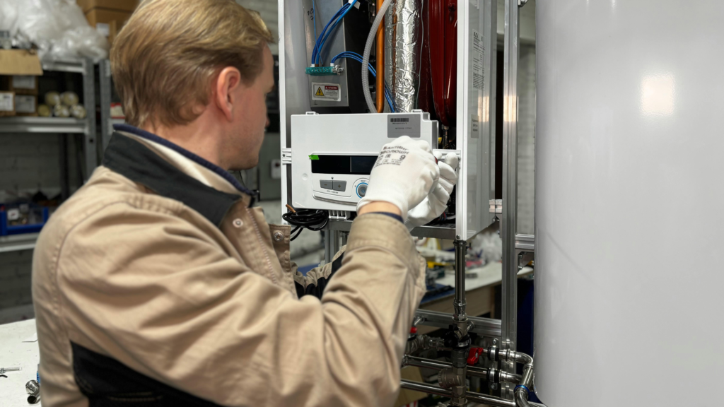 Technician repairing a furnace control board in a Rockford home